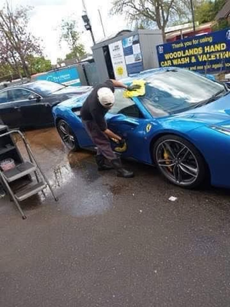 Our team hand washing a Ferrari